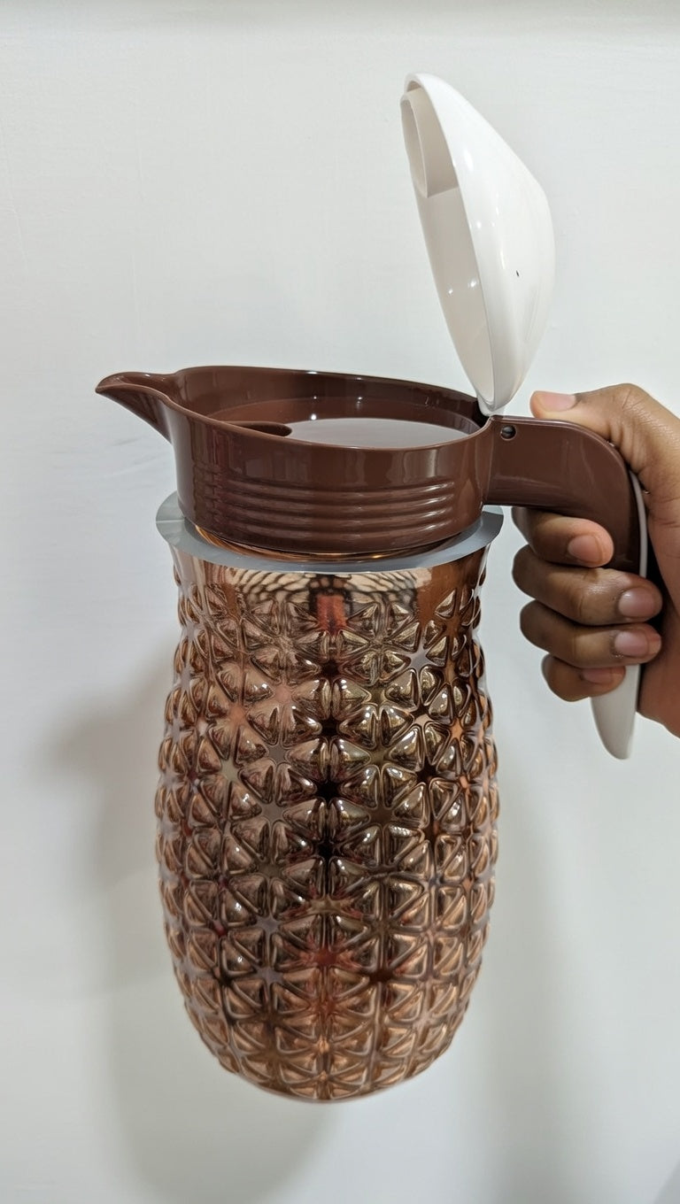 Pineapple textured glass jug with a brown plastic lid and handle.