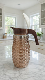 Pineapple textured glass jug with a brown plastic lid and handle.