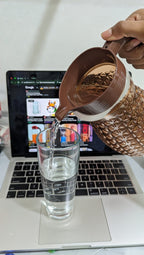 Pineapple textured glass jug with a brown plastic lid and handle.