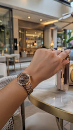 Rose gold dial women's watch with a stainless steel strap,